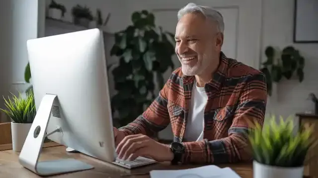 Jobs In Canada For Seniors - Senior man working in a home office with a computer