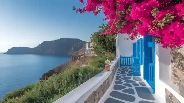 Top 10 Cheapest Hotels In Greece - Charming budget hotel on a Greek island with lush greenery and coastline